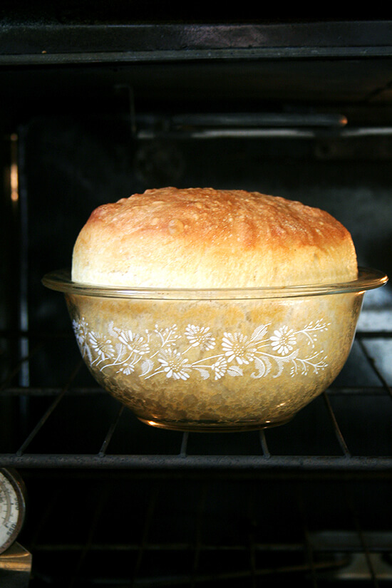 Side view close-up of peasant bread baking in oven