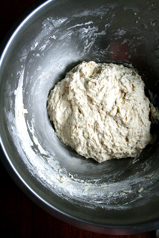 Overhead view of just-mixed dough in metal mixing bowl