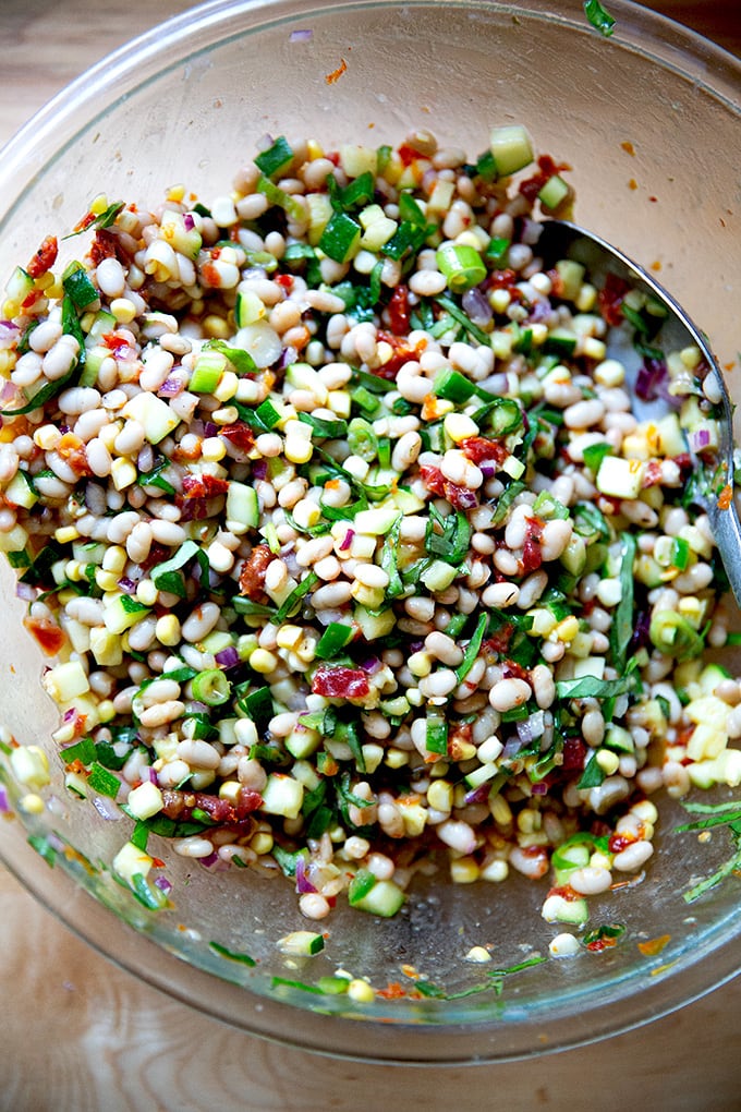 A bean salad all tossed together in a large bowl.
