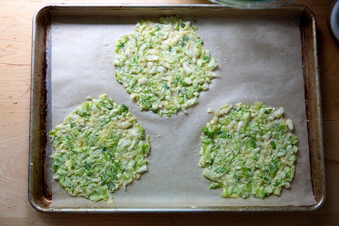 Cabbage tortilla batter spread in three circles on a sheet pan.