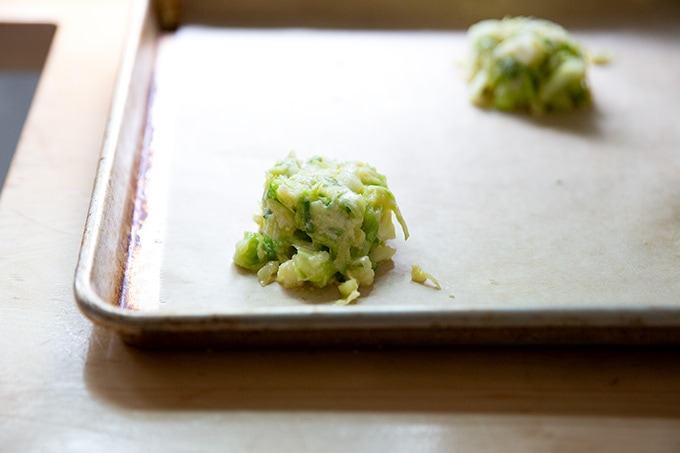Cabbage tortilla batter in a small mound on a sheet pan.