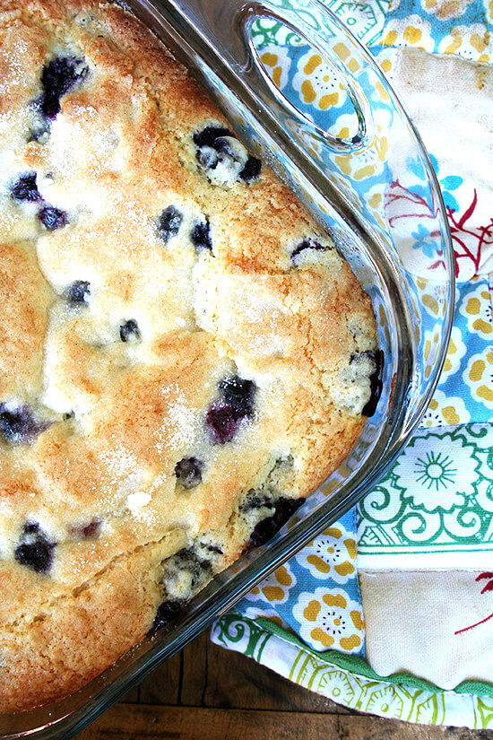 Overhead close-up of buttermilk blueberry breakfast cake in glass oven-safe baking dish