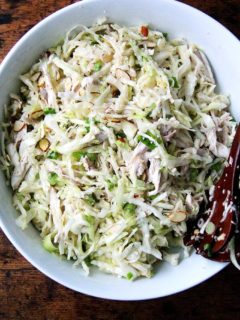 A large bowl of chicken and cabbage salad.