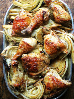 A platter of sheet pan chicken and cabbage.