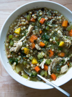 A bowl of simple, homemade chicken soup with fregola.