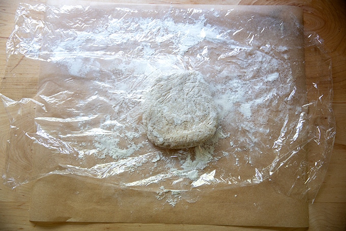 Sourdough cracker dough on a sheet of parchment paper.