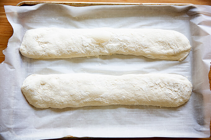 Ciabatta baguettes shaped on a sheet pan.