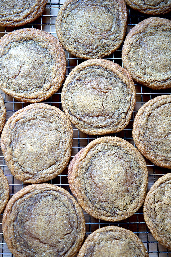 Just-baked gingersnap cookies on a cooling rack.
