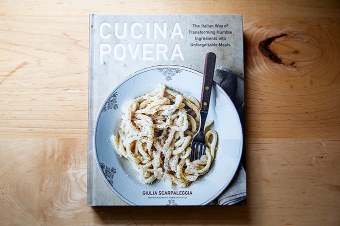 Cucina Povera, a cookbook, sitting on a countertop.