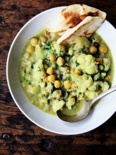 A pot of curried chickpeas with cauliflower and coconut milk.