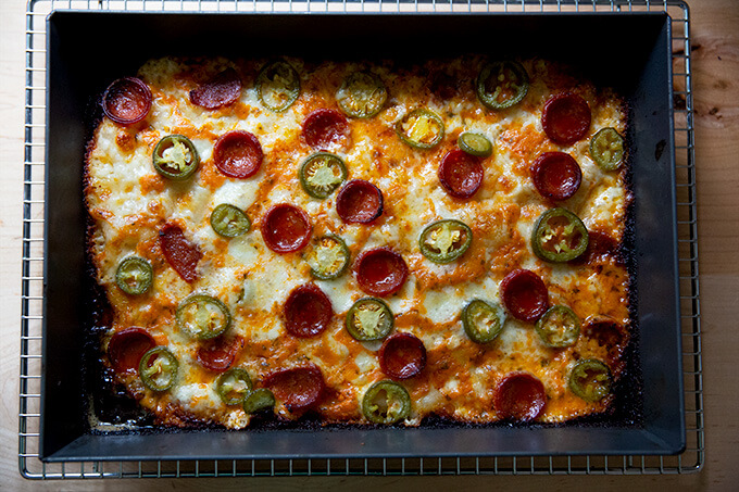 Just-baked Detroit style pizza in the pan topped with pickled jalapeños and pepperoni.