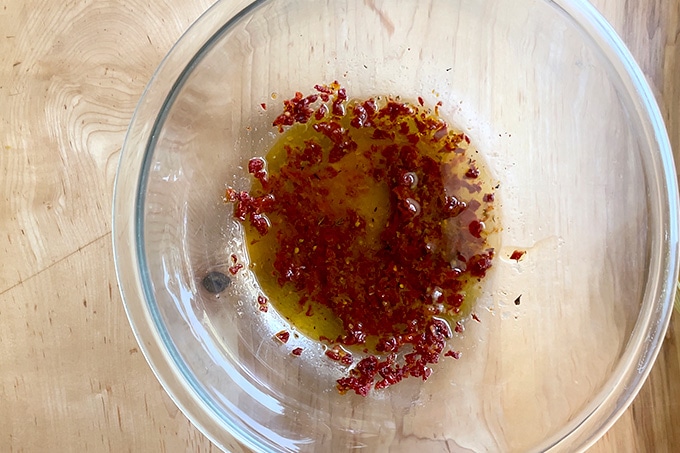 A bowl filled with a sun-dried tomato dressing.
