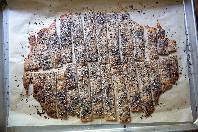 Just-baked sourdough crackers on a sheet pan.