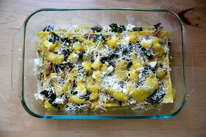 An assembled but unbaked vegetable lasagna in a baking dish.