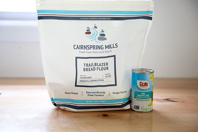 A bag of Cairnspring Mills flour and a small jar of pineapple juice.
