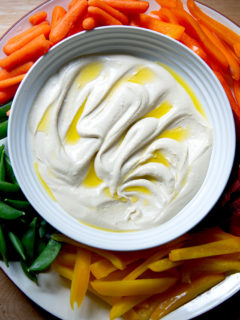 A platter of hummus and vegetables.