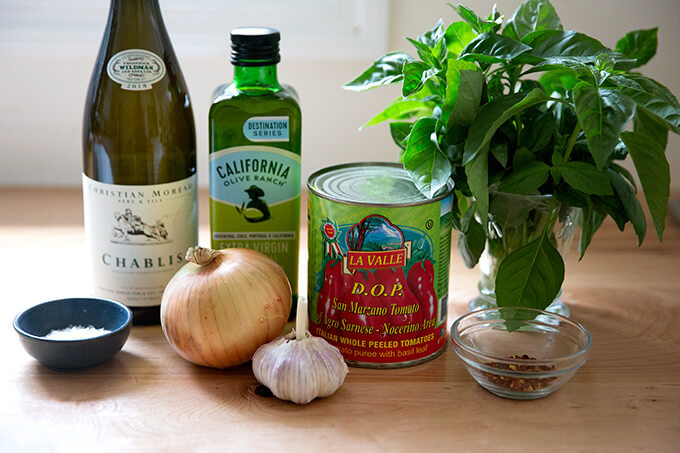 Ingredients to make quick, homemade tomato sauce from canned tomatoes.