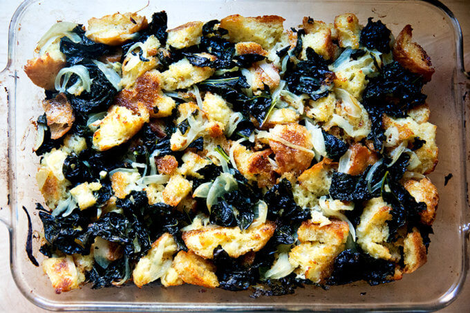 A 9x13-inch pan filled with kale and caramelized onion stuffing. 