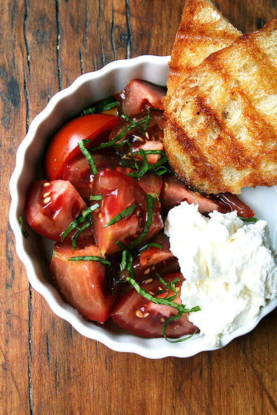 A summer lunch: tomatoes, grilled bread, homemade ricotta