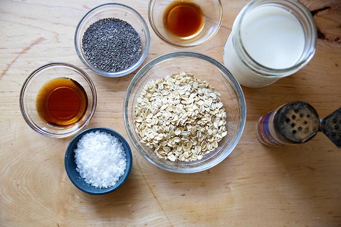 The ingredients to make overnight chia oats all measured in separate bowls on a countertop.