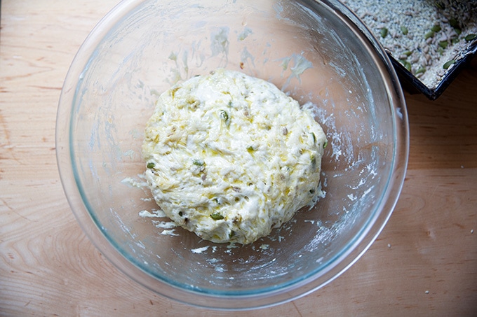 A bowl of three seed bread dough, oiled and punched down after the first rise.