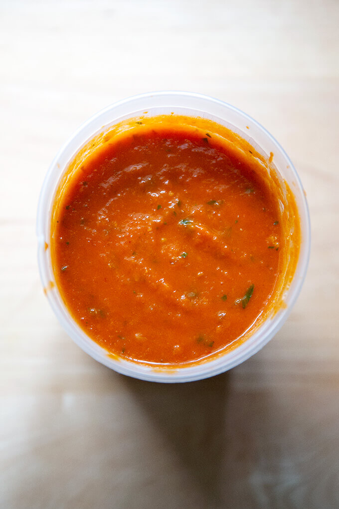 An overhead shot of homemade tomato sauce in a quart container.