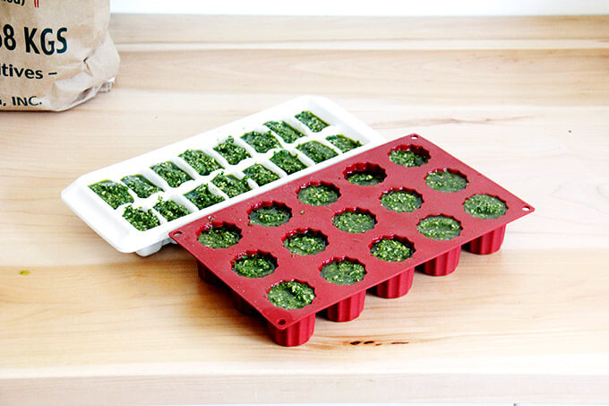 Ice Cube trays filled with basil pesto.