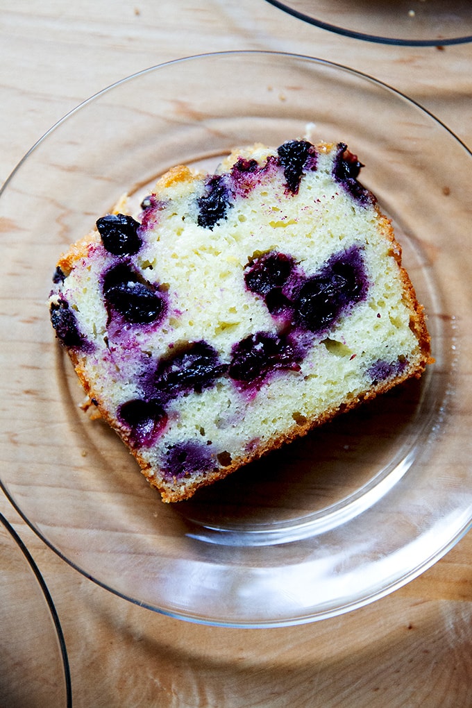 A slice of lemon blueberry quick bread on a plate.