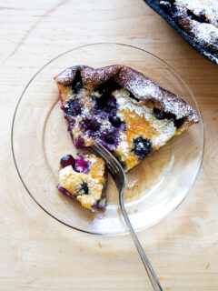 A slice of a blueberry Dutch baby on a plate.