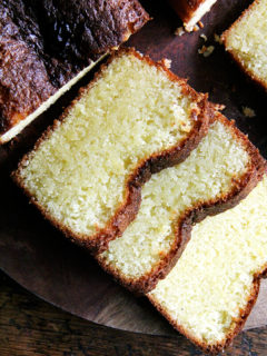 A sliced loaf of lemon semolina cake.