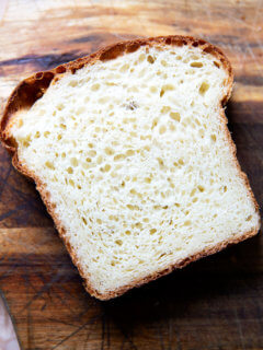 A slice of brioche bread on a cutting board.