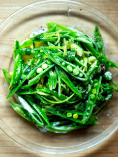 A plate of sugar snap pea salad with buttermilk dressing.