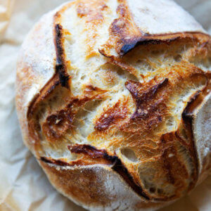 A scored loaf of sourdough bread.
