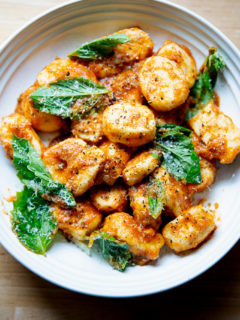 A bowl of ricotta gnocchi tossed in tomato sauce, basil, and parmesan.