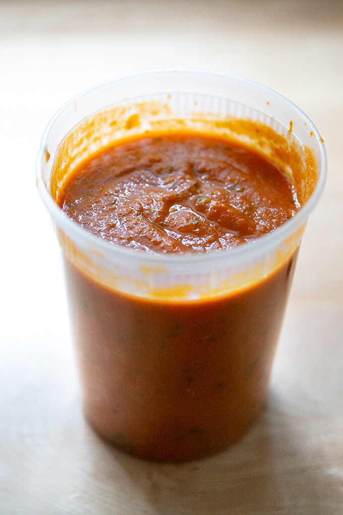 Homemade tomato sauce in a quart container.