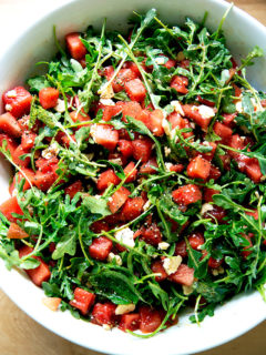 A tossed watermelon and feta salad in a bowl.